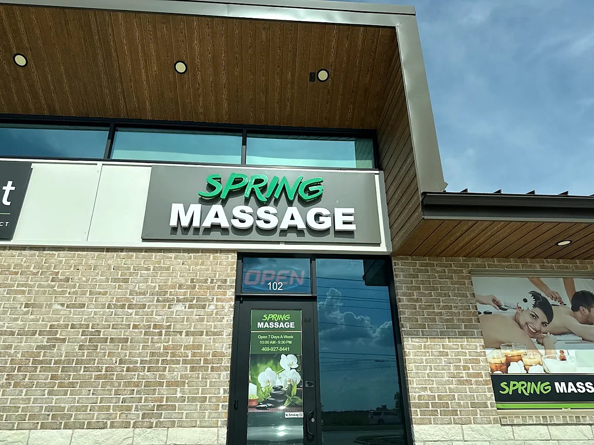 The Spring Massage storefront on North Coit Road — green SPRING and white MASSAGE lettering above suite 102